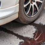 Car leaking fluid onto concrete