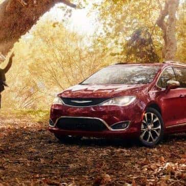 2018 Chrysler Pacifica parked in forest by a tree