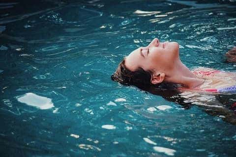Woman floating in a pool in louisville, ky