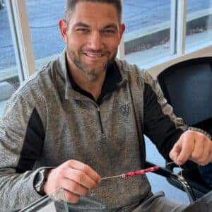team member and the bracelet they are making