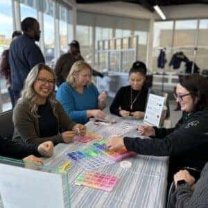 team members making bracelets