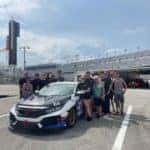 The Buckeye Honda Racing Team stands around the car at the Daytona International Speedway