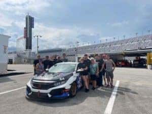 The Buckeye Honda Racing Team stands around the car at the Daytona International Speedway