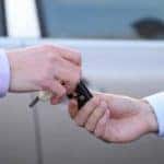 man giving keys to a car