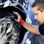 Man washing wheels of a car
