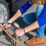 Woman inflating tire