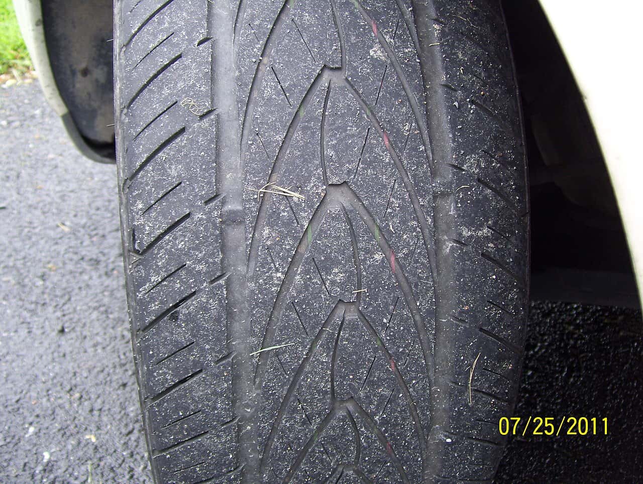 Close-up of car-tire tread with its original 2011 camera date imprint