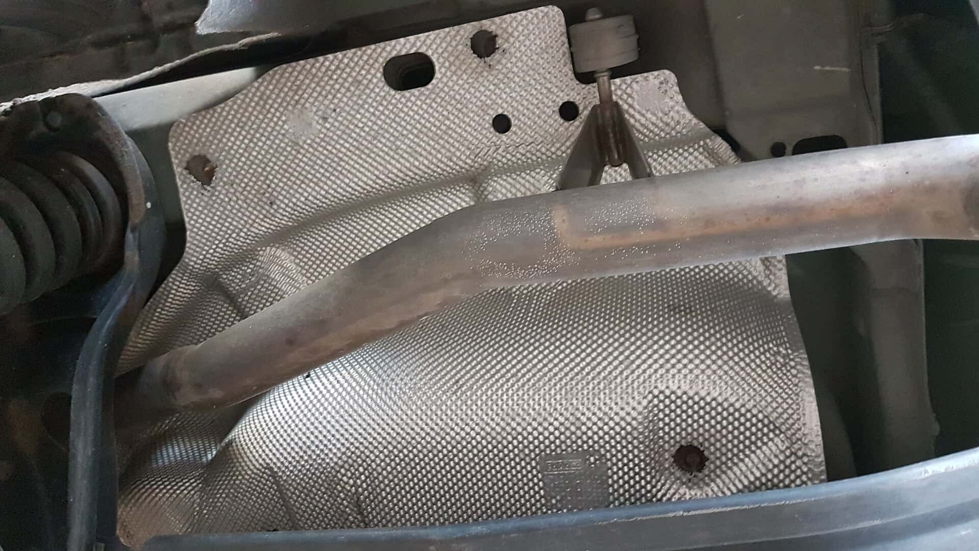 Aluminum exhaust heat shield above an exhaust pipe on a 2011 Ford Focus