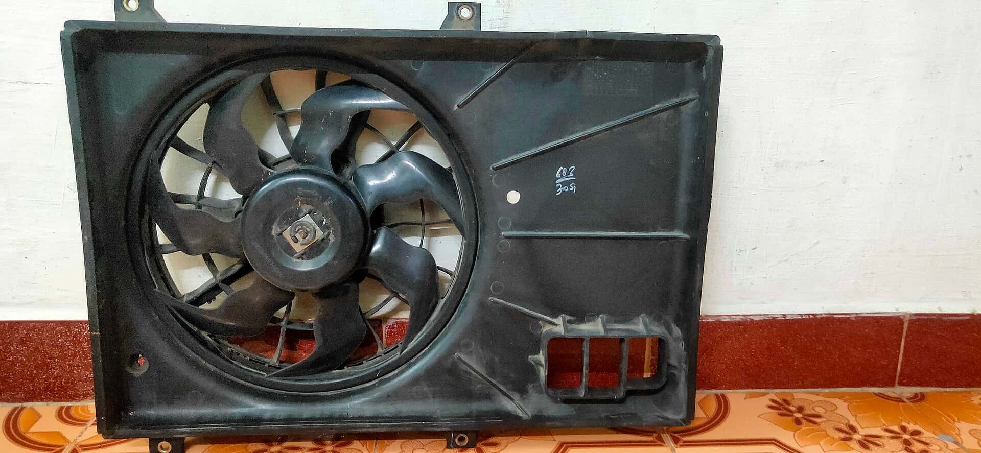 Removed automotive radiator cooling fan and black shroud
