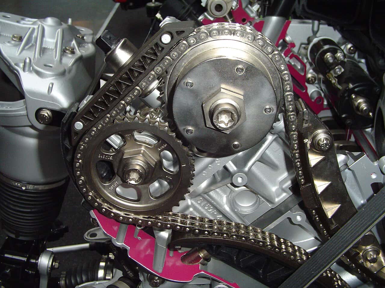Exposed timing chain, sprockets and chain guide on a museum engine cutaway