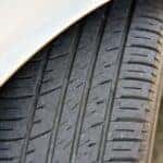 Close view of a tire tread with grooves and wear bars