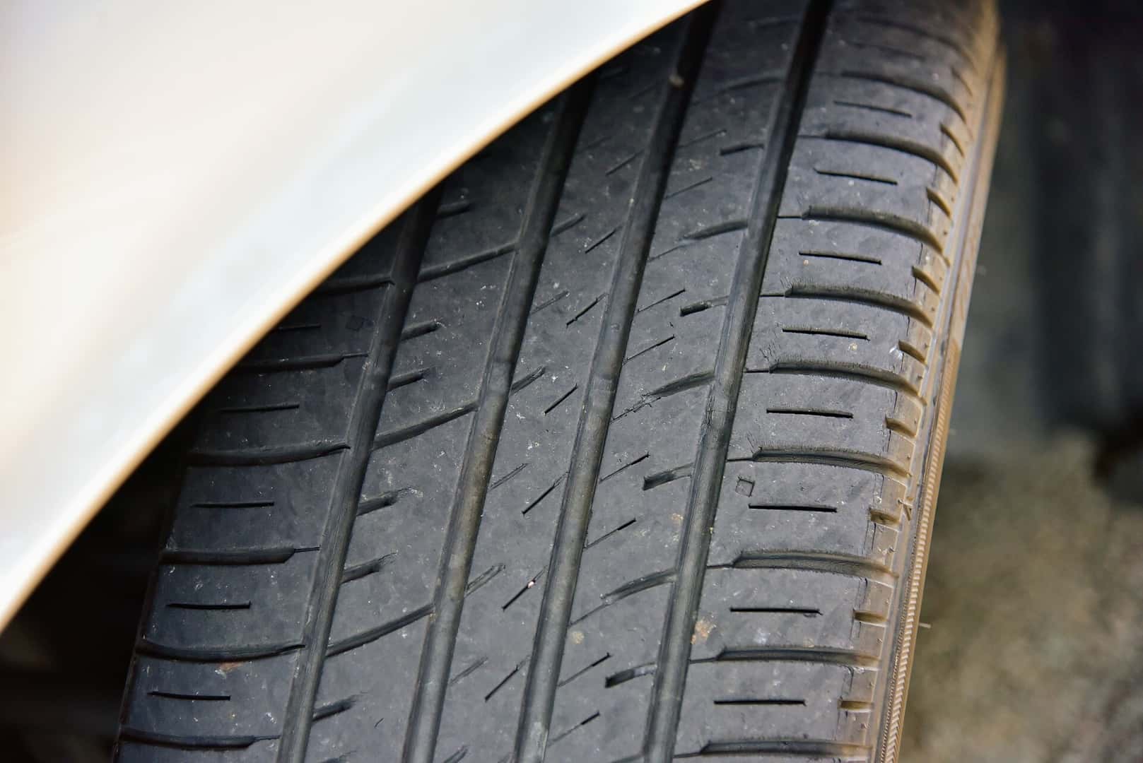 Close view of a tire tread with grooves and wear bars