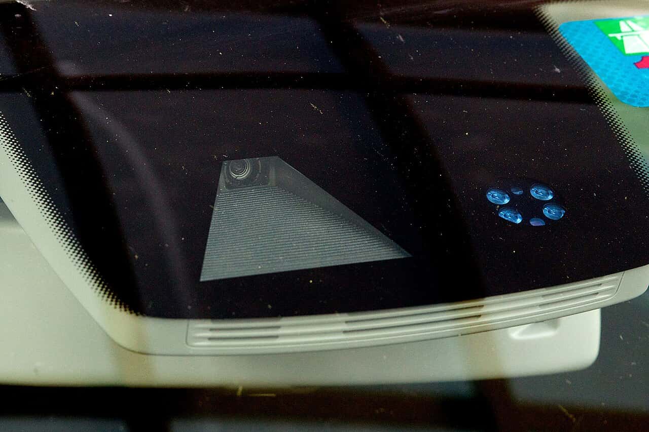 Lane-assist camera lens behind the windshield of a Volkswagen Golf