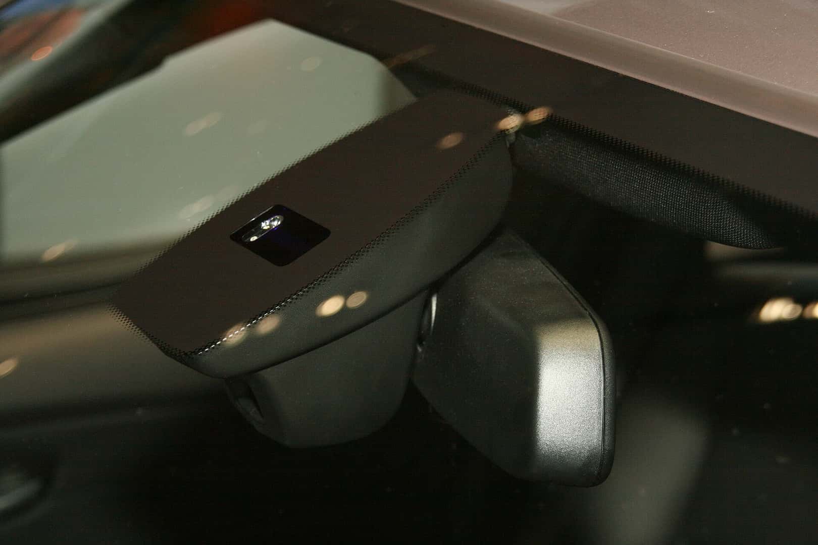 Rain-sensor window on a car windshield above the interior rearview-mirror housing