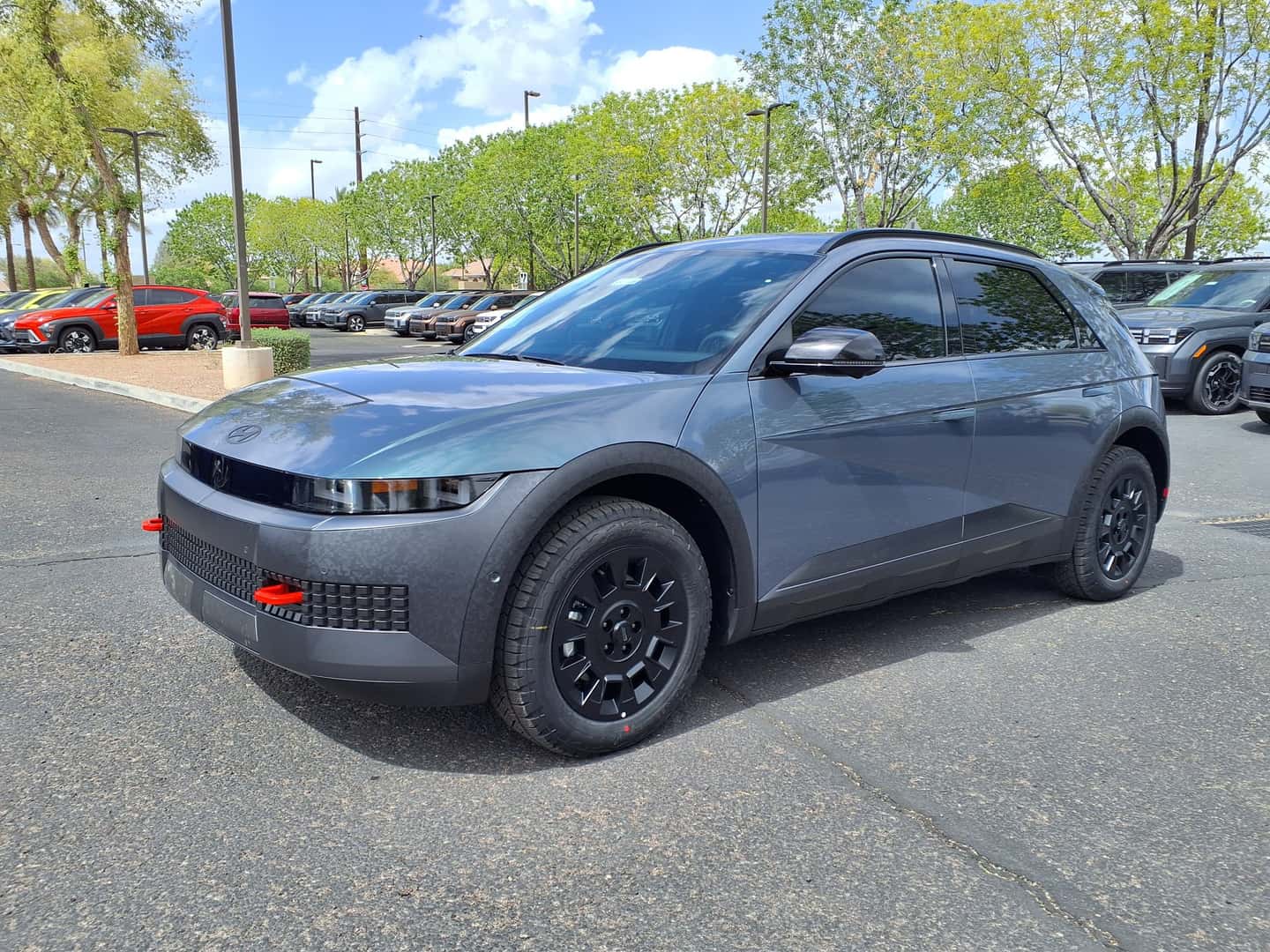 Gray 2025 Hyundai Ioniq 5 XRT viewed from the front and side, with red front recovery hooks