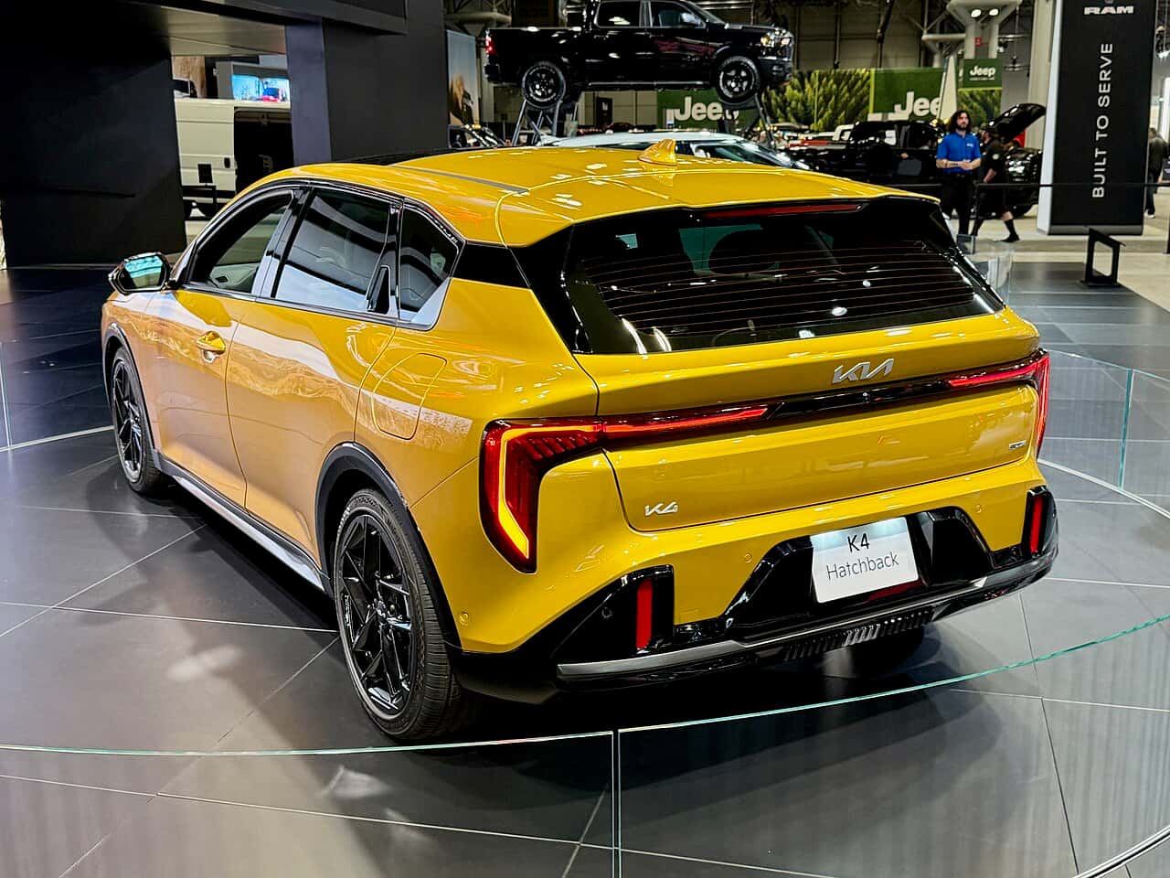 Rear view of a yellow 2026 Kia K4 Hatchback at the 2025 New York International Auto Show