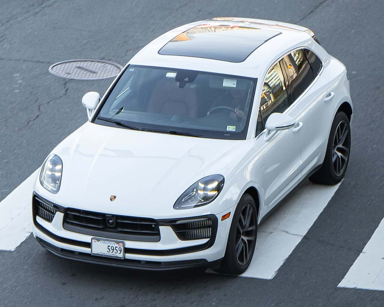 White Porsche Macan S of the gasoline 95B generation viewed from above at a street crossing
