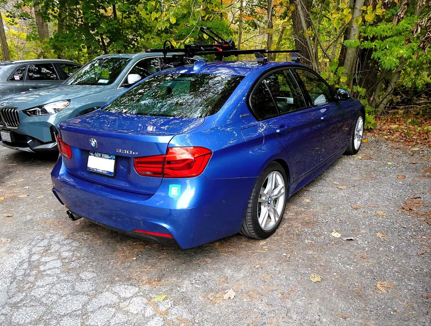 Blue 2018 BMW 330e F30 plug-in hybrid sedan viewed from the rear
