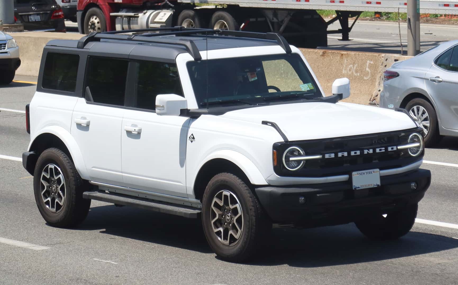 White 2022 Ford Bronco Outer Banks four-door SUV viewed from the front and side