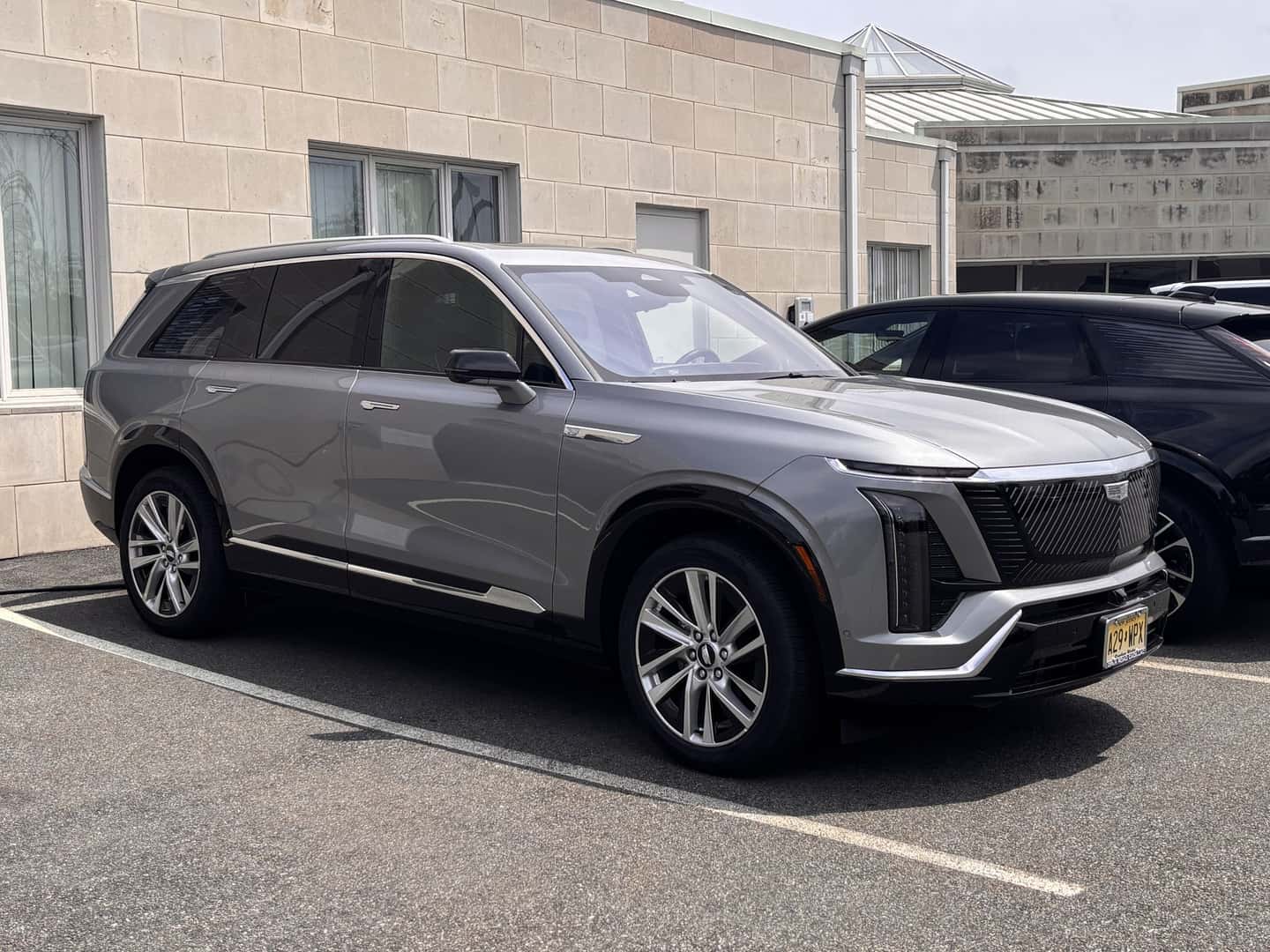 Silver 2026 Cadillac Vistiq Luxury SUV viewed from the front and side