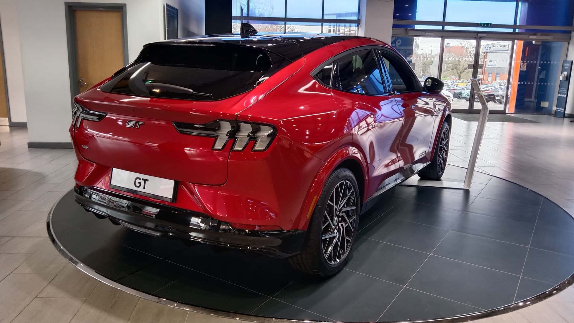 Red 2023 Ford Mustang Mach-E GT viewed from the rear and right side