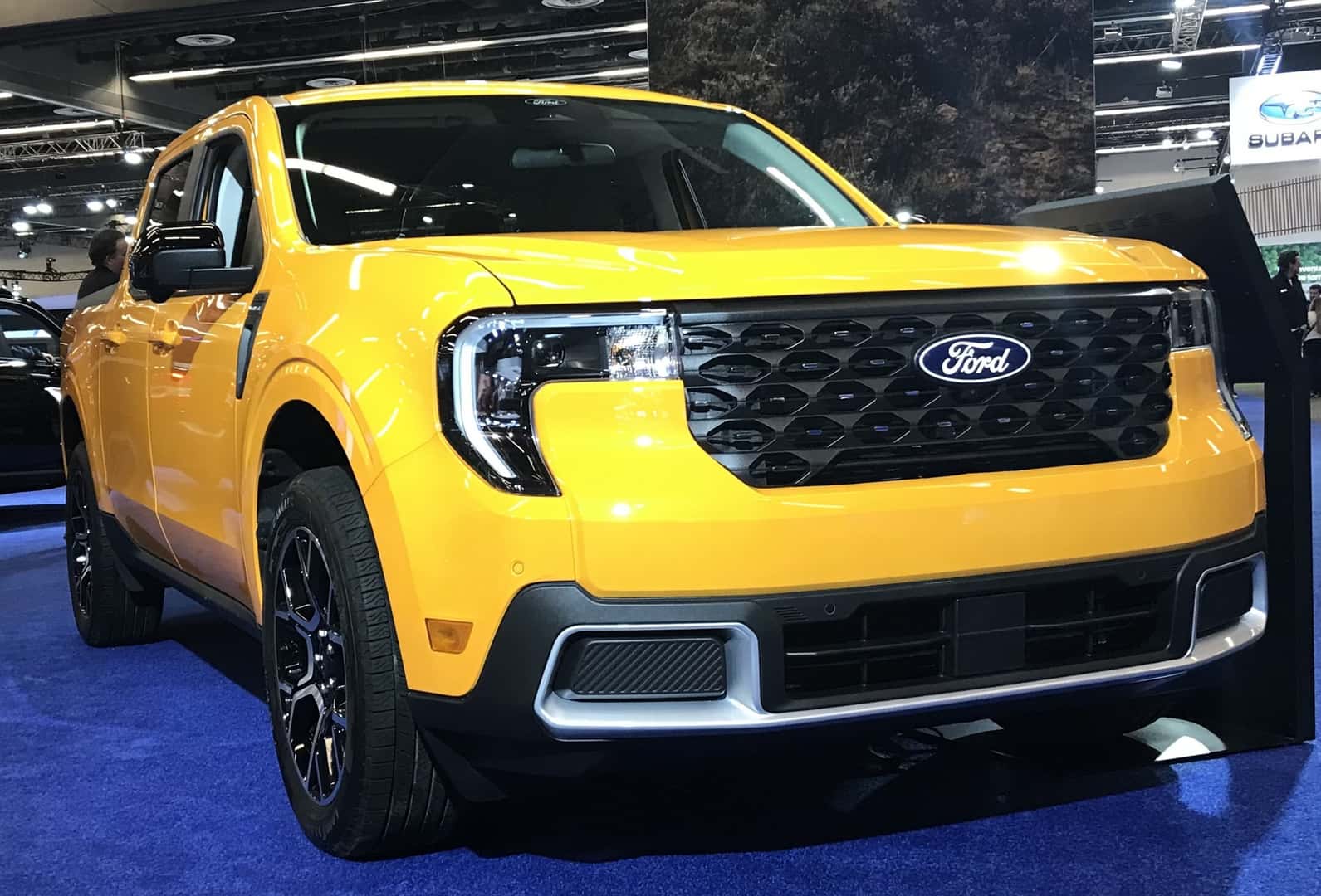 Yellow 2026 Ford Maverick pickup displayed at the Montréal International Auto Show