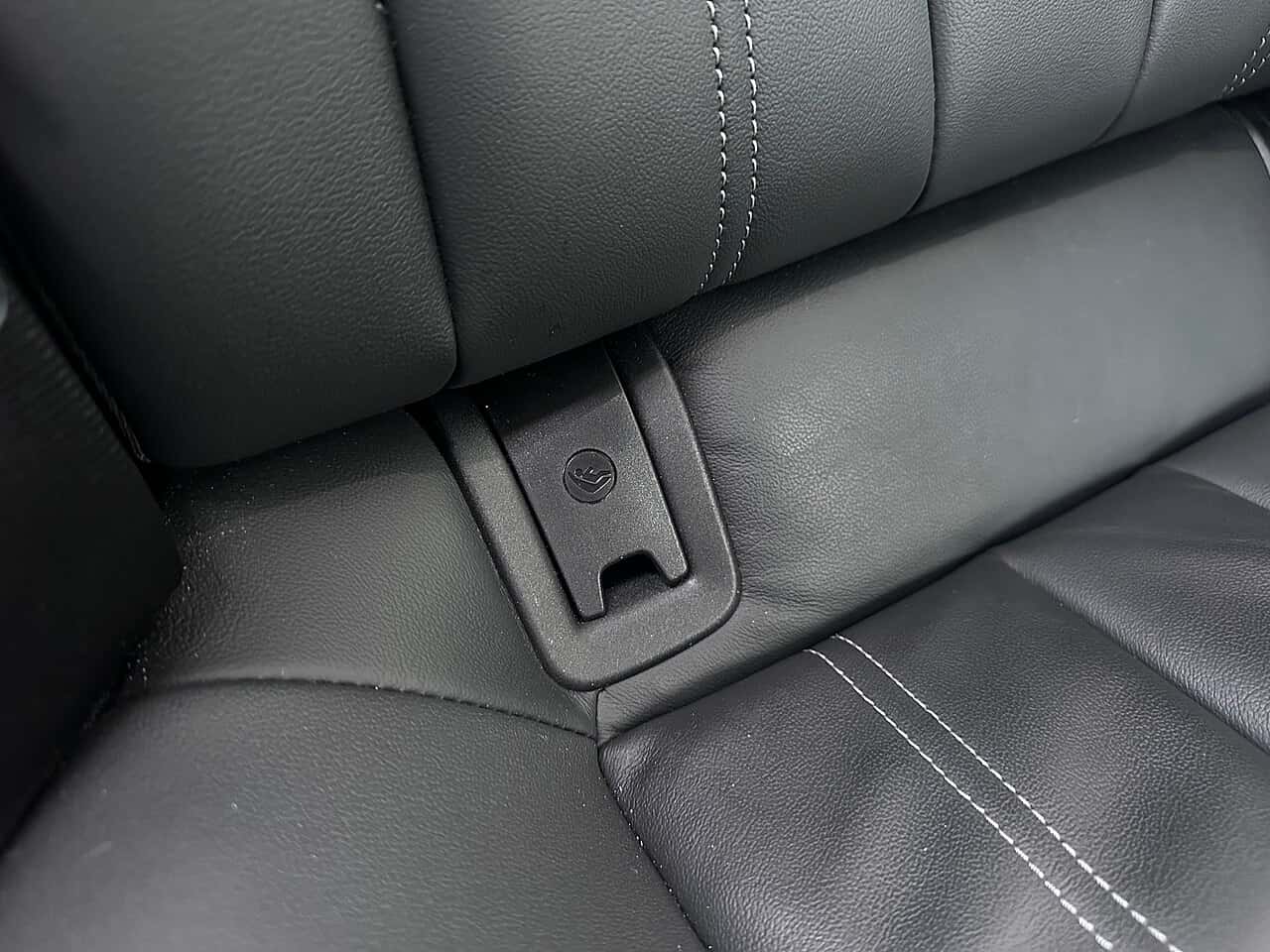 Closed ISOFIX access cover with a child-seat symbol between rear-seat cushions in a 2023 Audi A4 allroad