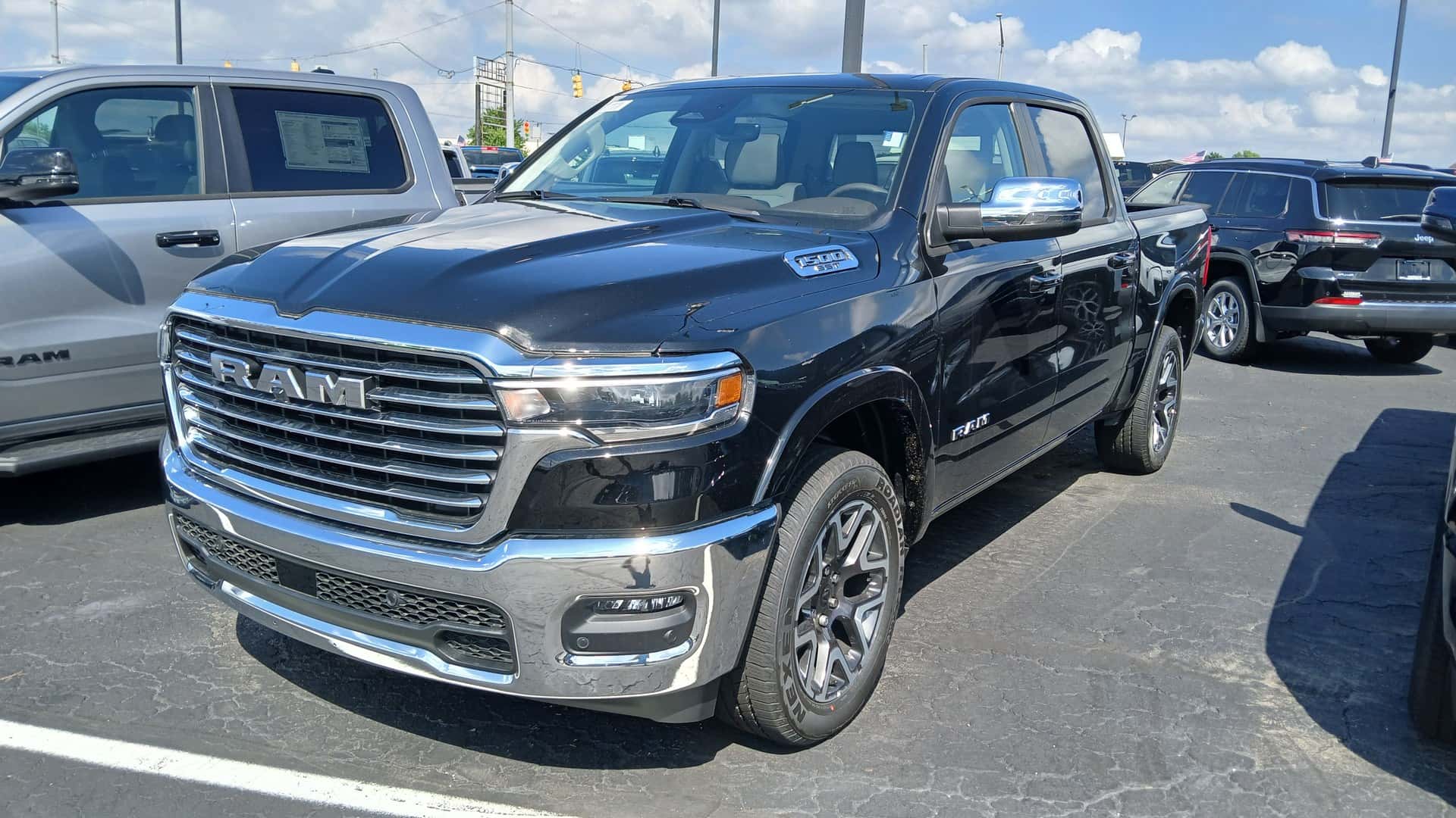 Dark blue Ram 1500 DT crew cab pickup viewed from the front and side