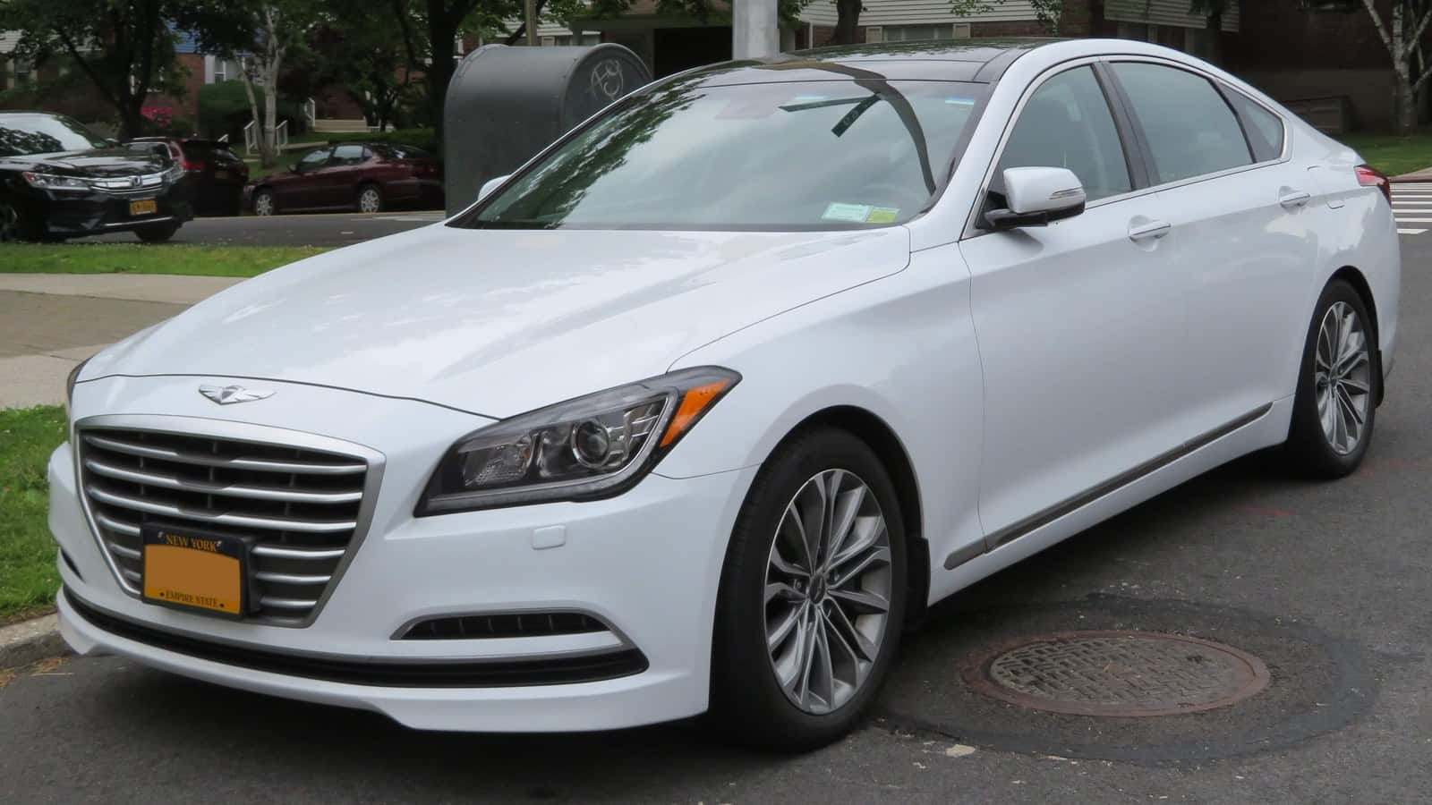 White 2015 Hyundai Genesis sedan viewed from the front and driver’s side.