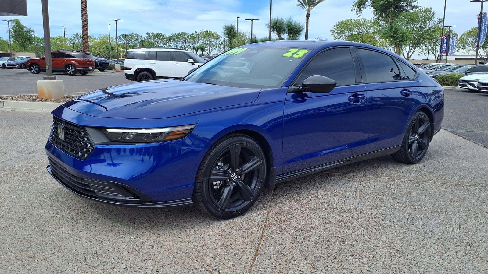 Blue 2023 Honda Accord Hybrid Sport-L sedan viewed from the front left.