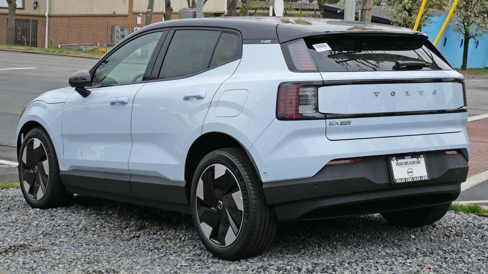 Light blue 2025 Volvo EX30 electric SUV viewed from the rear left.