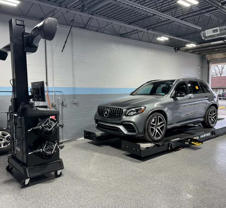 Mercedes-Benz SUV on an alignment rack at Cooper Automotive