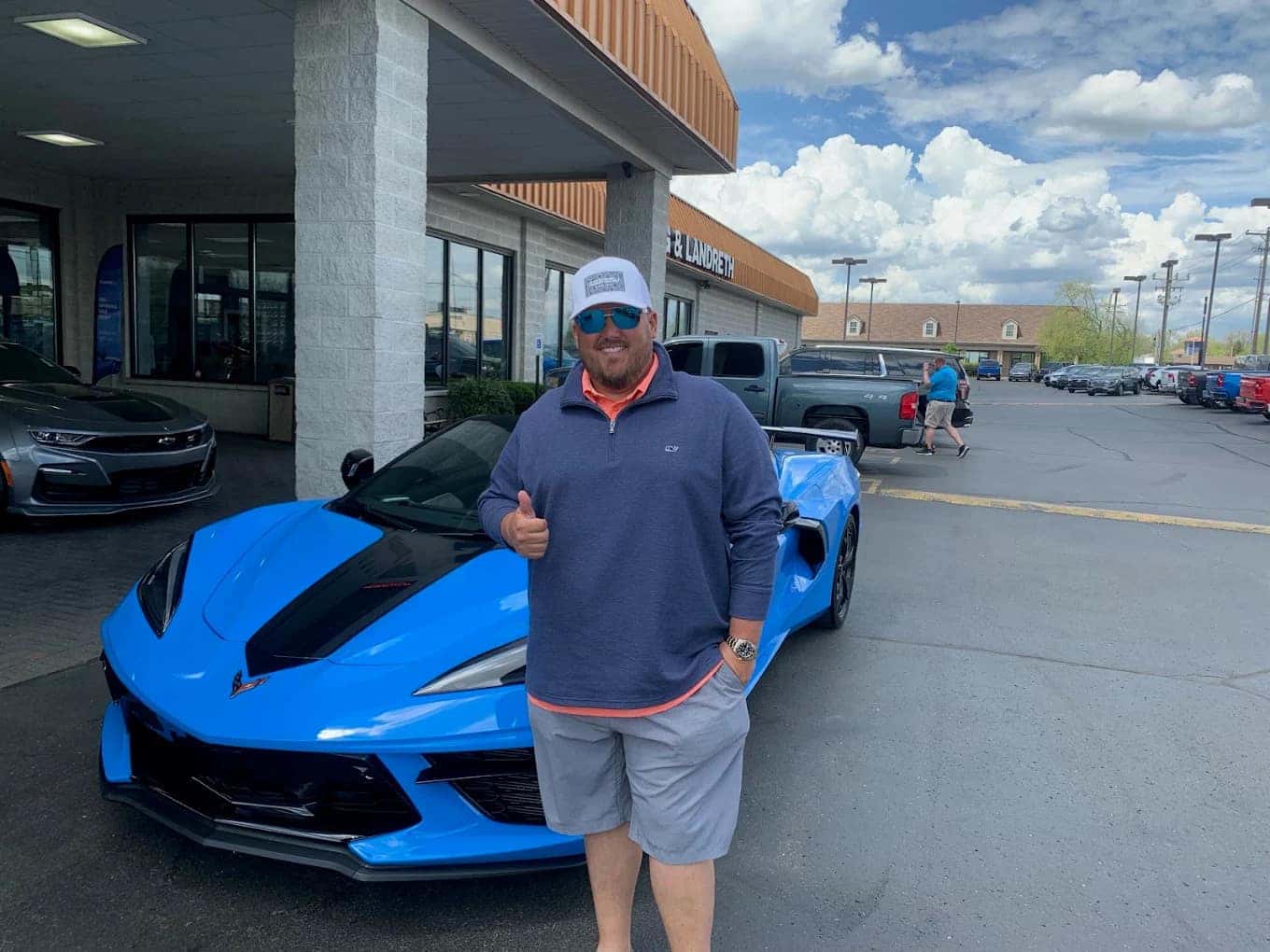 Man beside a blue Chevrolet Corvette outside Craig & Landreth in Clarksville