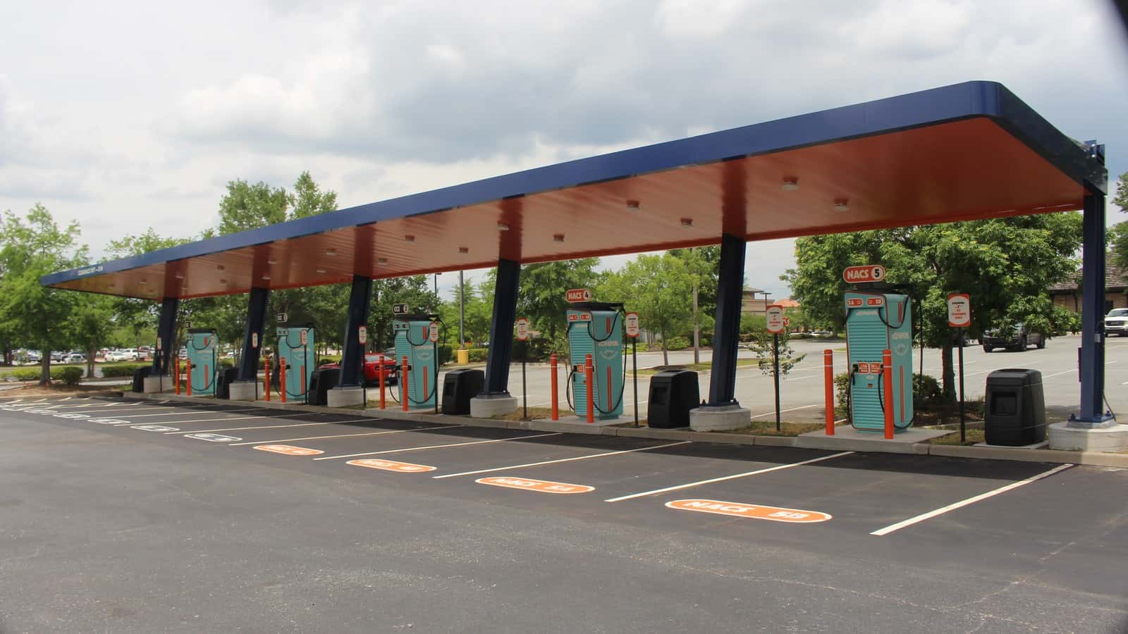 A row of IONNA electric-vehicle charging dispensers under the canopy at the Valdosta, Georgia Rechargery Relay.