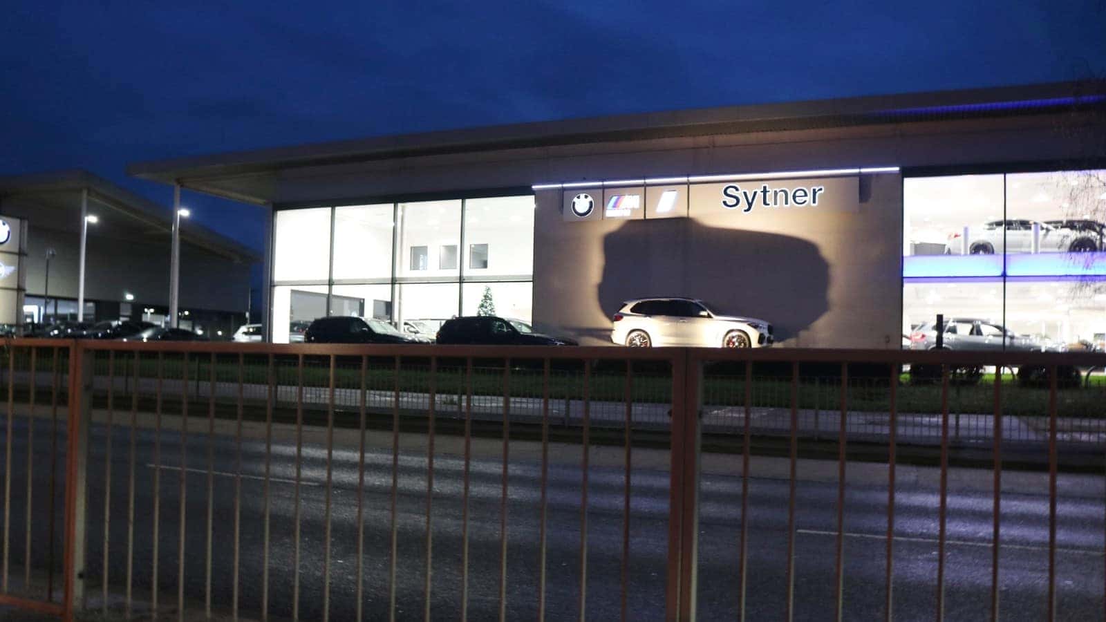 Sytner BMW dealership building and illuminated sign in Stevenage, England, in December 2022