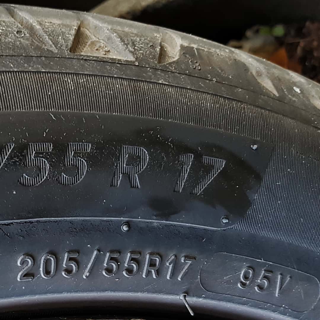 Close-up of a tire sidewall marked 205/55 R17 with the service description 95V.
