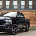 Black 2020 Ram 1500 in front of modern building