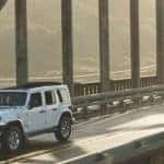 jeep wrangler driving over bridge