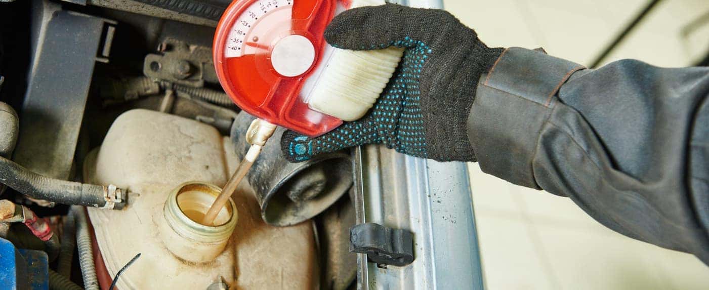 mechanic checking antifreeze