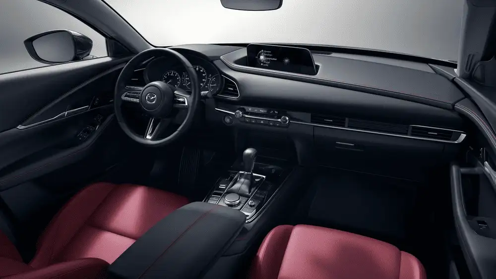 2026 Mazda CX-30 interior with black dashboard and red leather seats in Hempstead NY