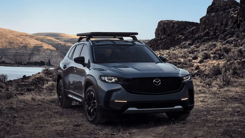 2026 Mazda CX-50 parked outdoors near rocky landscape showcasing rugged design in Hempstead NY
