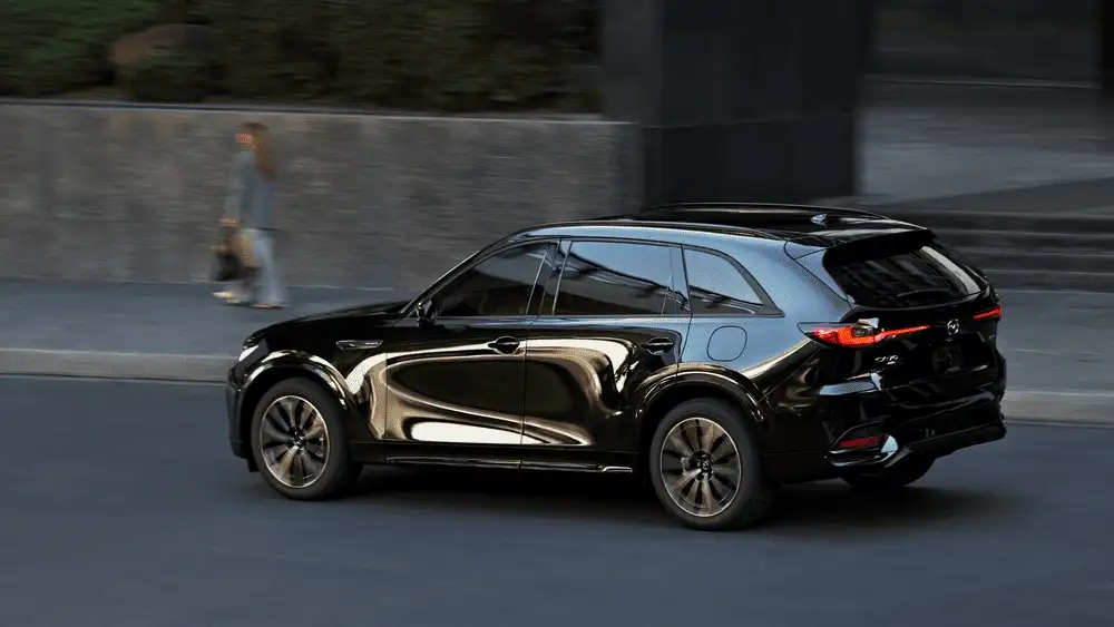 2026 Mazda CX-70 driving on highway with city skyline in background near Hempstead NY