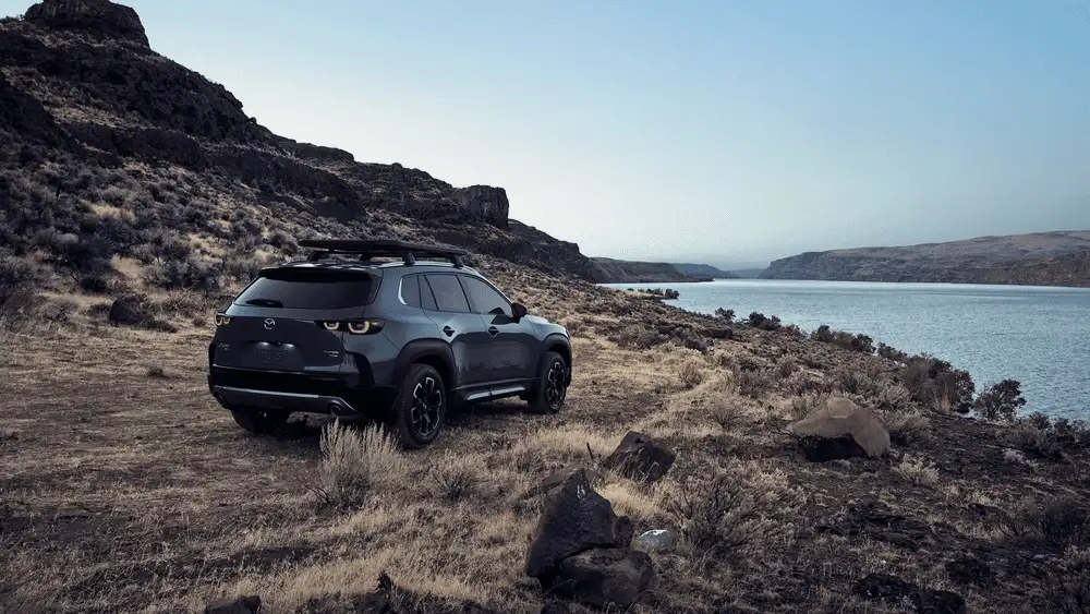 2026 Mazda CX-50 parked near scenic lake highlighting rugged capability in Hempstead NY