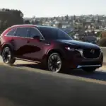 2026 Mazda CX-90 driving on elevated highway with city view in Hempstead NY