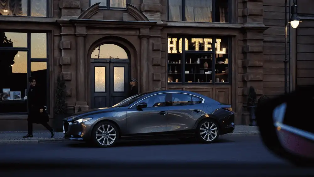 2026 Mazda3 Hatchback parked on city street with modern building background in Hempstead NY