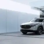 2026 Mazda CX-30 near Uniondale NY in silver parked outside a modern minimalist home with large glass doors