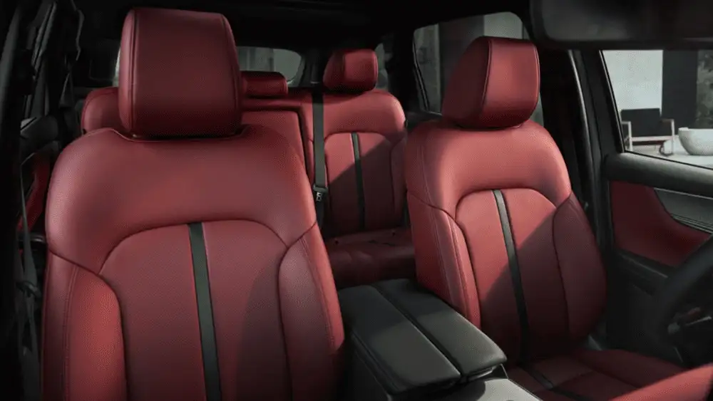 2026 Mazda CX-70 near Uniondale NY three-row red leather seating interior with black seatbelts and center armrest in second row