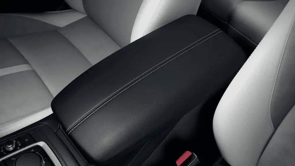 2026 Mazda CX-30 close to Uniondale NY interior with light gray leather seats, black dashboard and center console, and mountain range visible through side windows