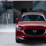2026 Mazda CX-30 near Uniondale NY, red SUV facing forward parked beside glass storefront windows
