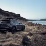 2026 Mazda CX-50 near Uniondale NY, dark gray SUV with roof rack parked beside a lake at dusk